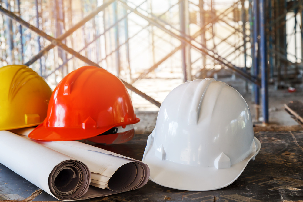 Helmet,And,Blueprint,On,Table,In,Construction,Site